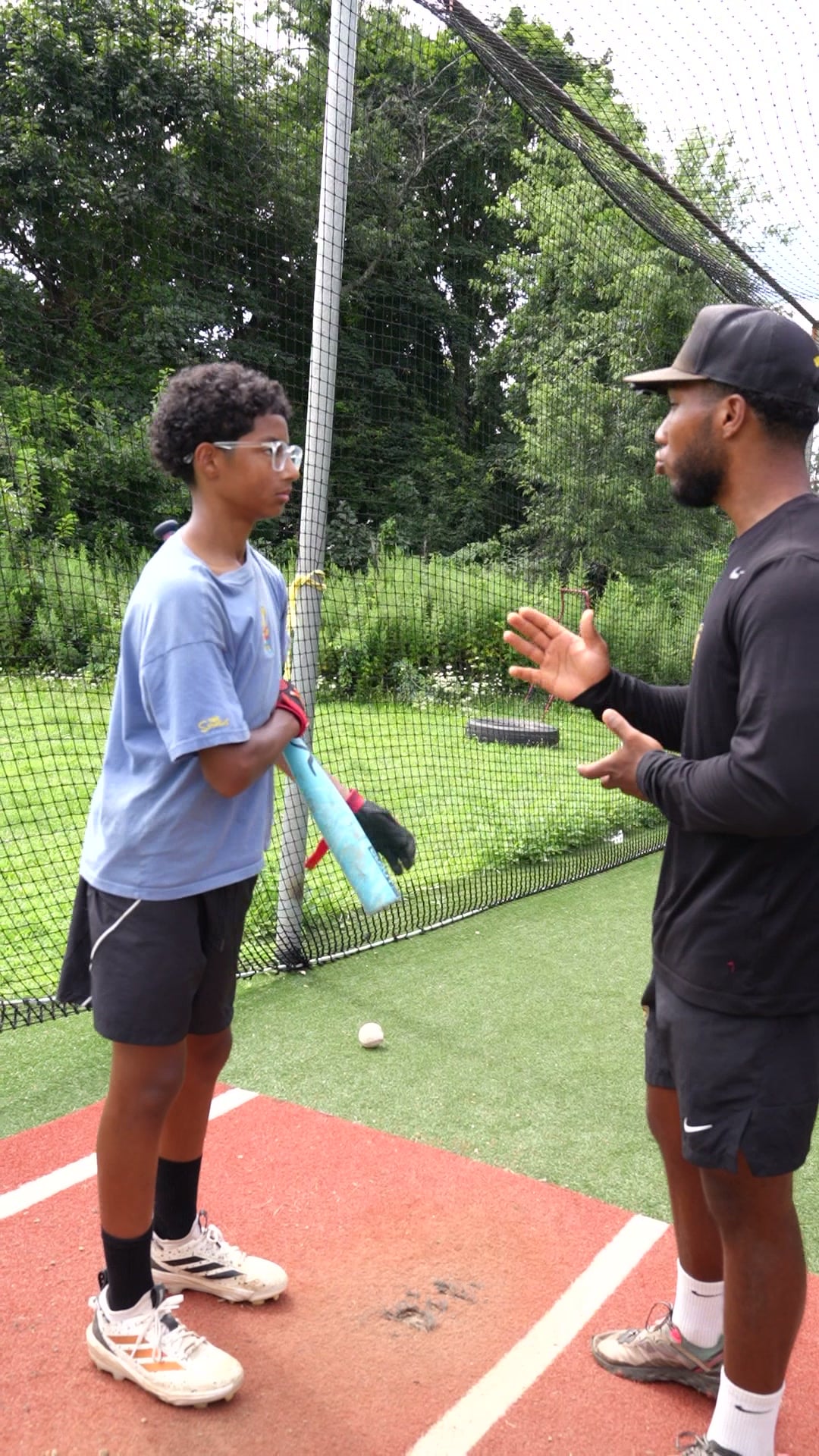 Baseball coach working with a player at GrindTime Baseball Academy in Bellerose, NY, Queens