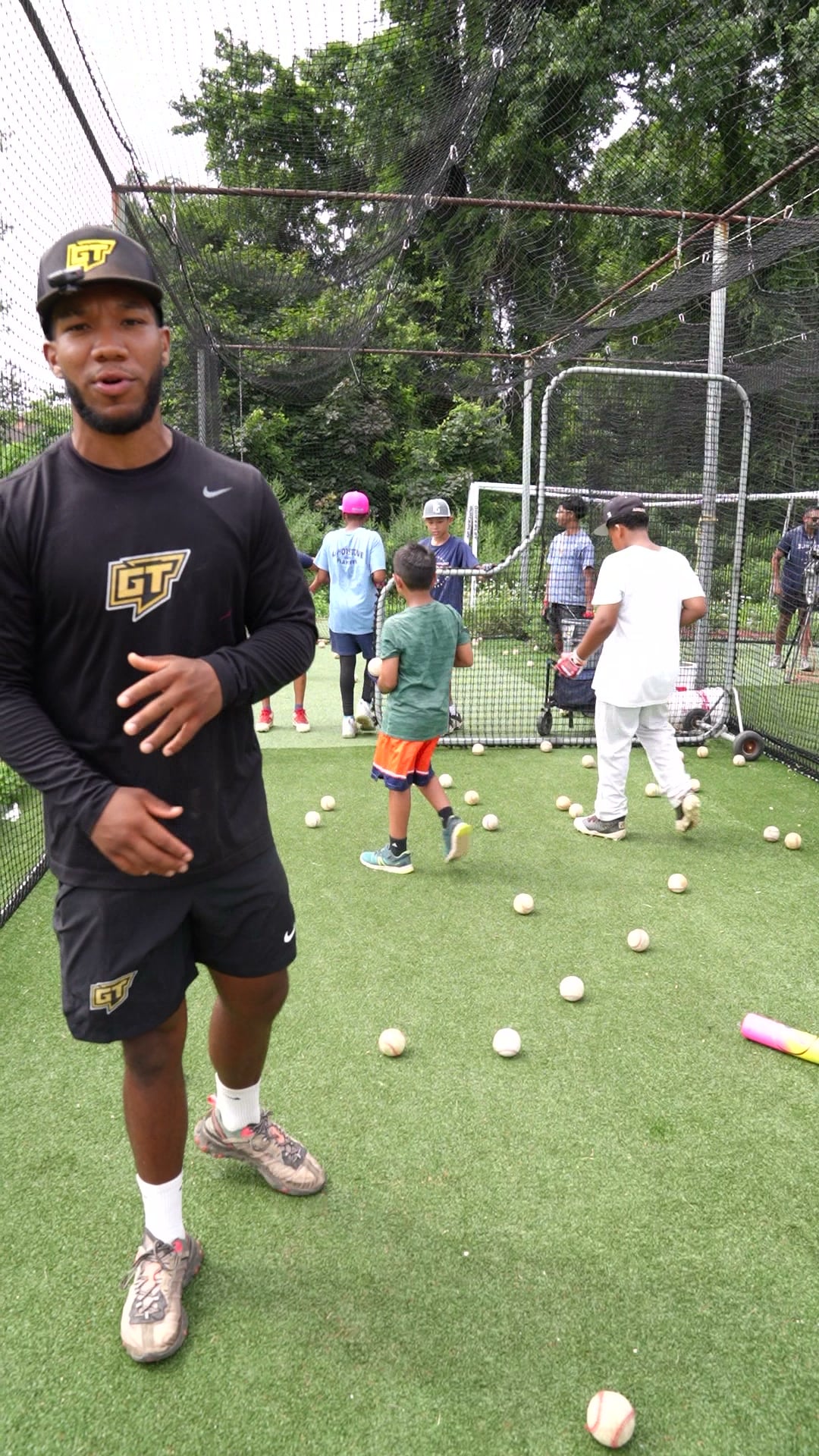 Baseball coach working with a player at GrindTime Baseball Academy in Bellerose, NY, Queens
