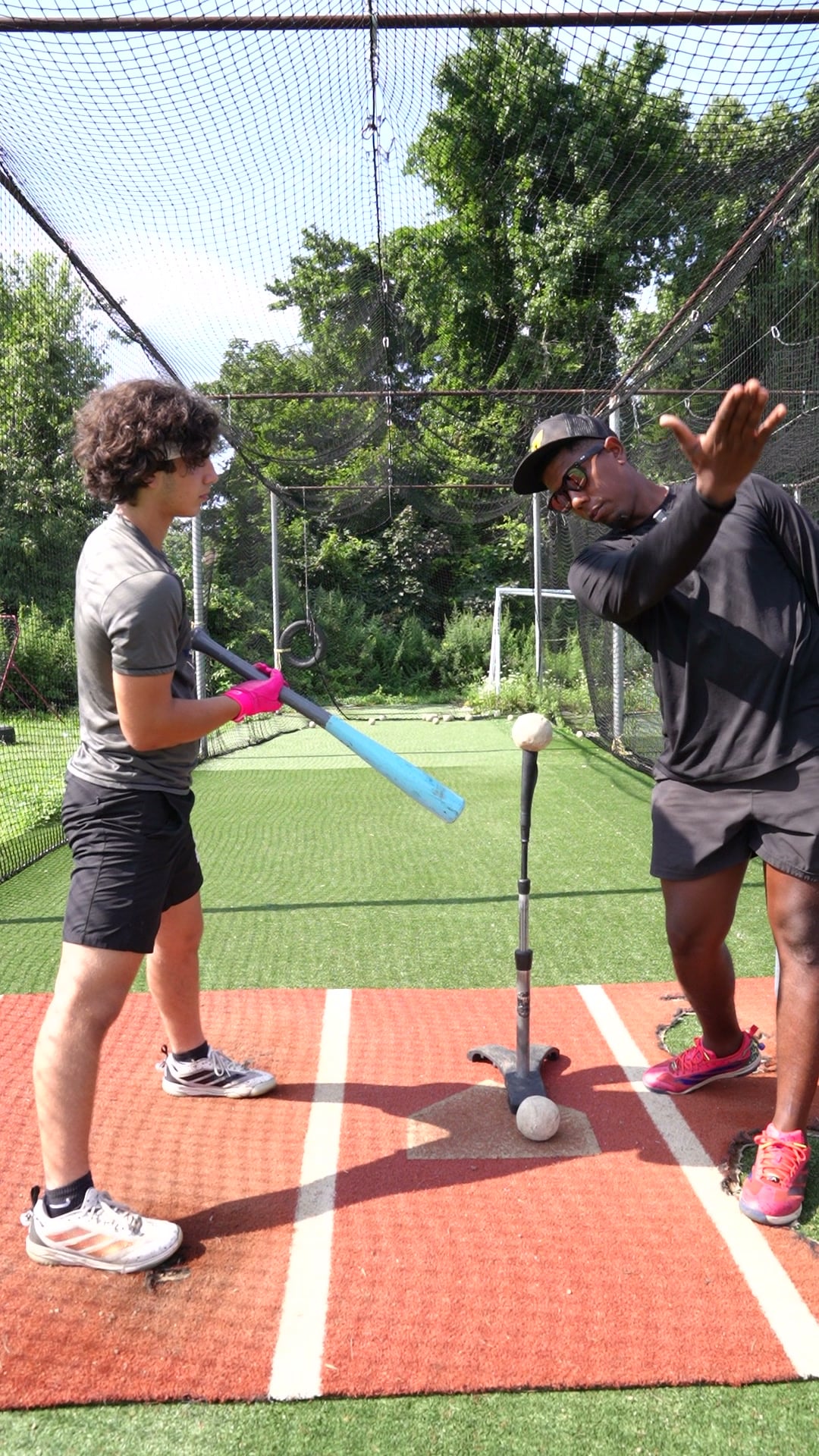 Baseball coach working with a player at GrindTime Baseball Academy in Bellerose, NY, Queens