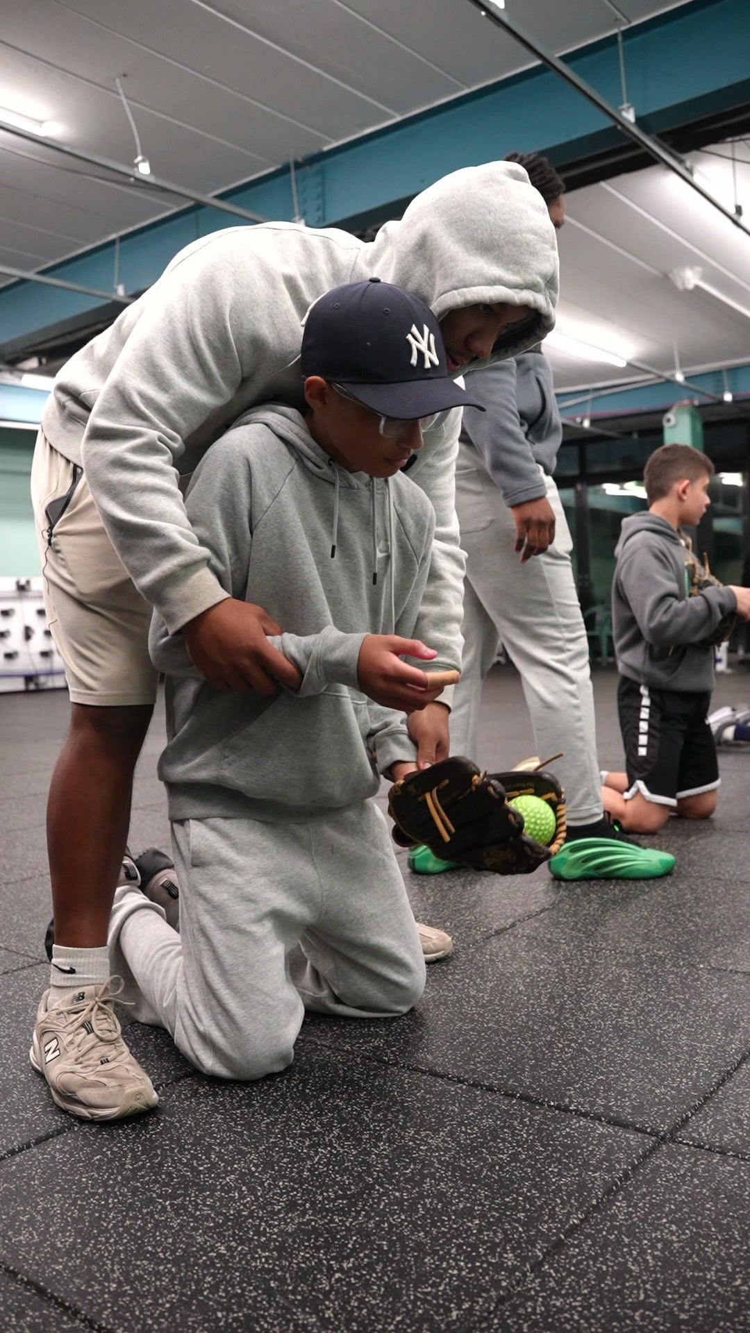 Baseball coach working with a player at GrindTime Baseball Academy in Bellerose, NY, Queens