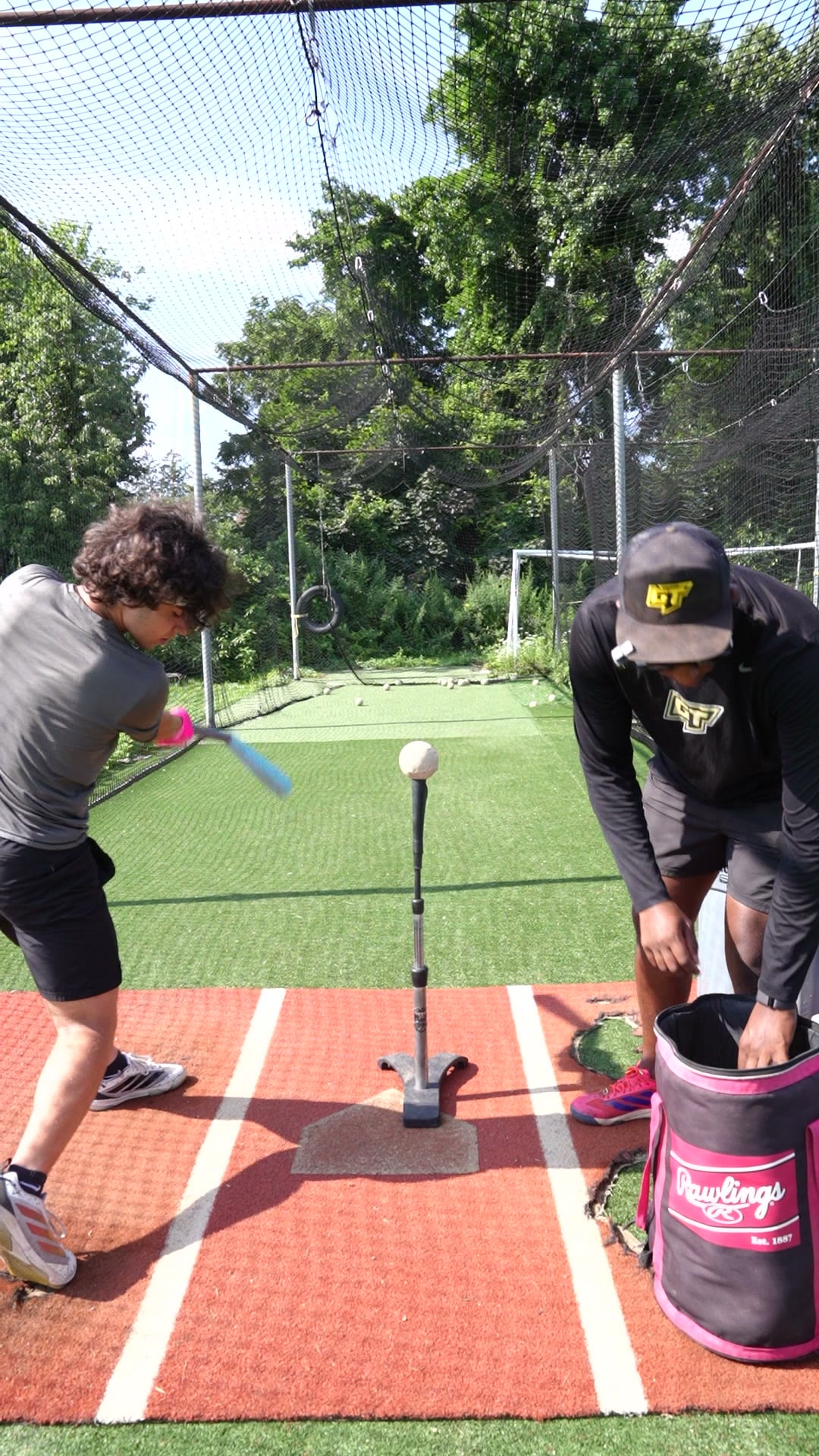 Baseball coach working with a player at GrindTime Baseball Academy in Bellerose, NY, Queens